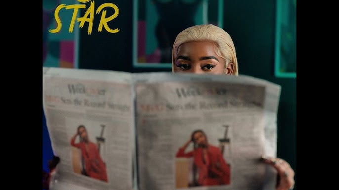 Ms Gideon holding a newspaper